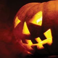 A scary old jack-o-lantern on black. Halloween pumpkin, trick or treat. Halloween holiday
