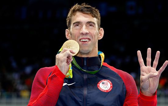 Michael Phelps with one of his 28 Olympic medals