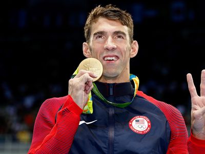 Michael Phelps with one of his 28 Olympic medals