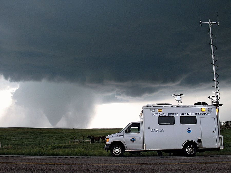 With the tornado in the background in Goshen County, Wyoming on June 5, 2009, the National Severe Storms Laboratory Field Command Vehicle helped coordinate operations in the field during the Verification of the Origins of Rotation in Tornadoes Experiment