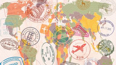 Opened passport with visas, stamps, seals, world map. (travel, tourism)